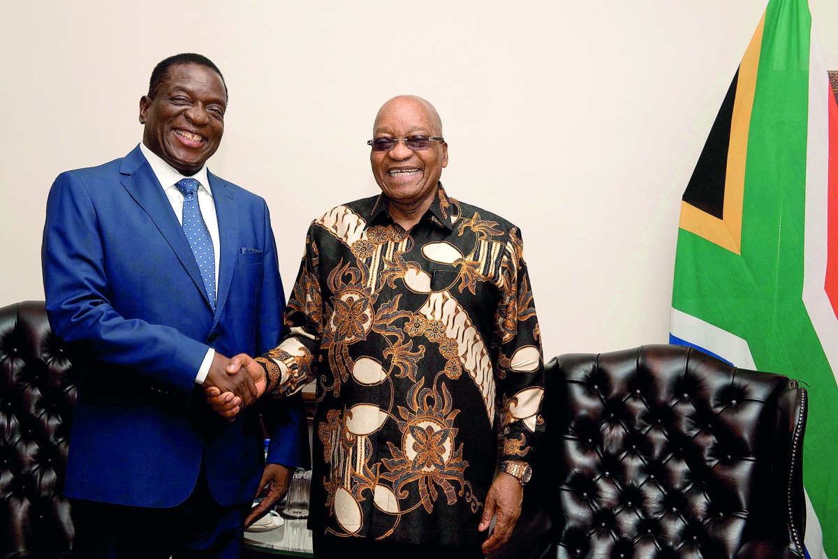 South African President Jacob Zuma (R) shakes hands with Zimbabwe's former vice president Emmerson Mnangagwa in Pretoria, South Africa November 22, 2017. Ntswe Mokoena/Courtesy of GCIS