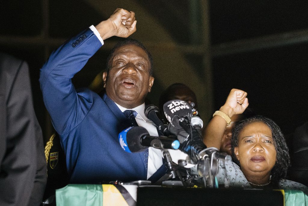 Zimbabwe's incoming president Emmerson Mnangagwa (L) speaks to supporters flanked by his wife Auxilia at Zimbabwe's ruling Zanu-PF party headquarters in Harare on November 22, 2017.   AFP / MARCO LONGARI
