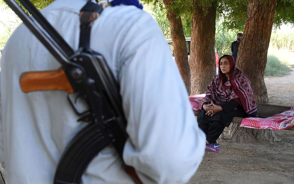 This photograph taken on September 27, 2017, shows Pakistani woman Mukhtiar Naz (R), known as Waderi Nazo Dharejo, meeting with workers near her home in Qazi Ahmed in Sindh province. AFP