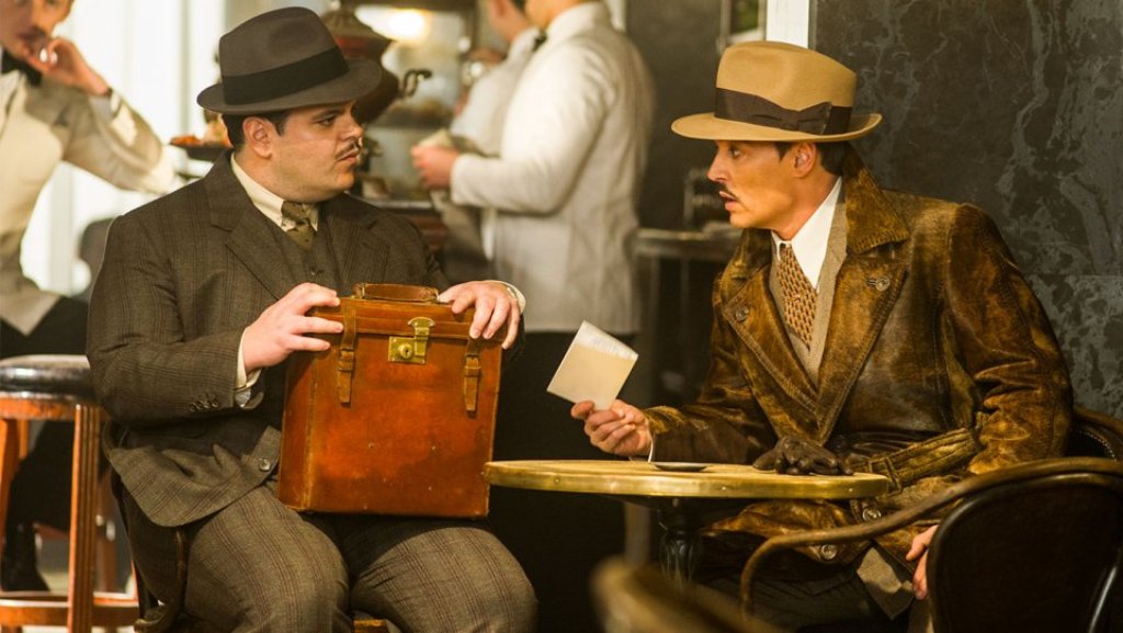 A still of actors Johnny Depp and Josh Gad (R) from the movie Murder on the Orient Express.