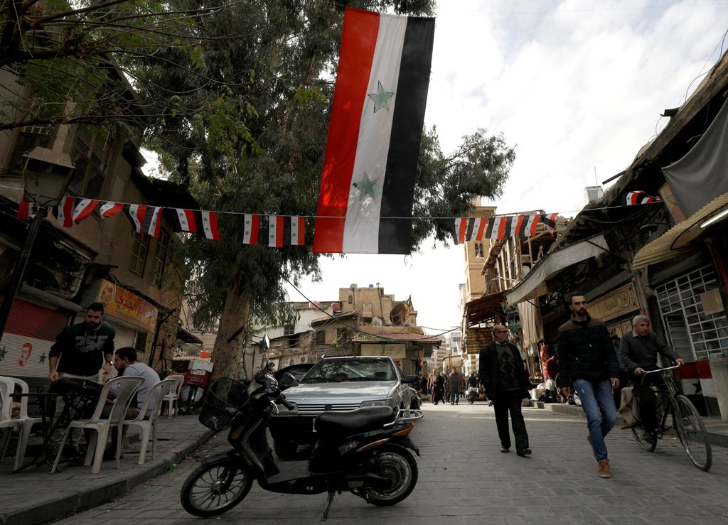 People walk along a street at Sarouja neighborhood in Damascus, Syria, November 26, 2017. REUTERS/Omar Sanadiki
