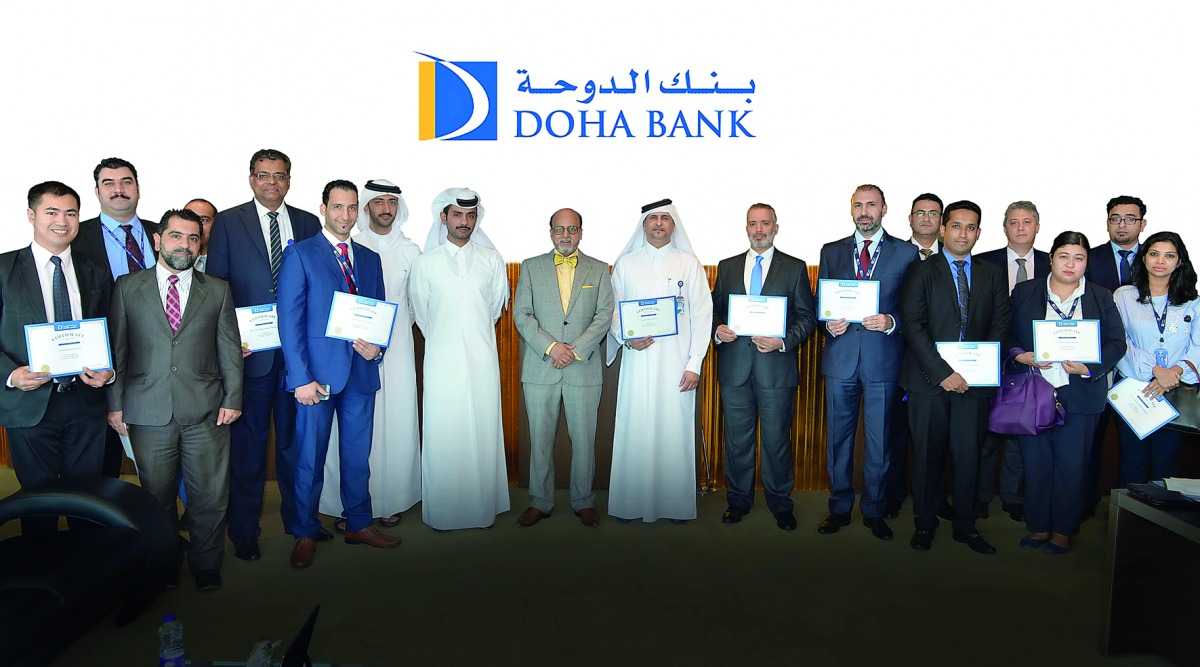 Dr R Seetharaman (centre), CEO Doha Bank; along with senior officials and employees of Doha Bank during the employee recognition awards event, at Doha Bank Tower in West Bay.