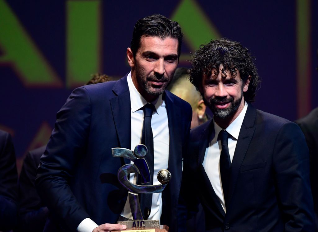 Juventus' Italian goalkeeper Gianluigi Buffon (L) poses with poses with AIC President Damiano Tommasi after receiving the 