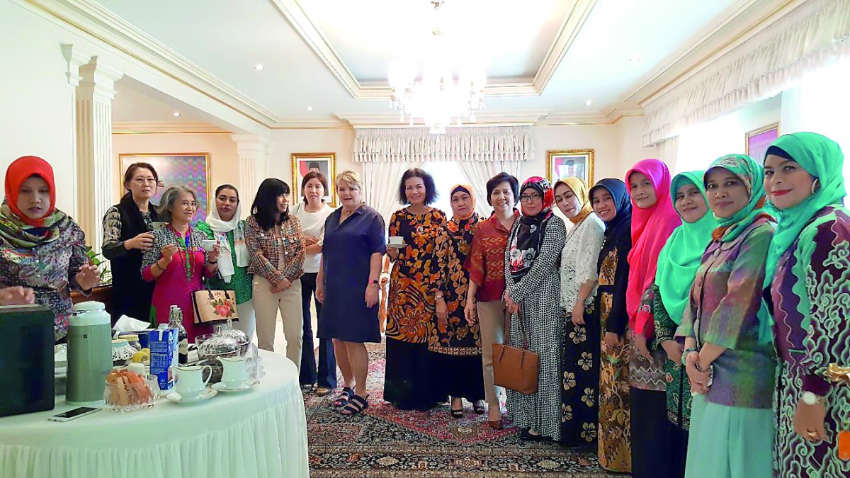 The wives of ambassadors from Asian and European embassies as well as expatriates from various countries sample various Indonesian coffees at the event . 