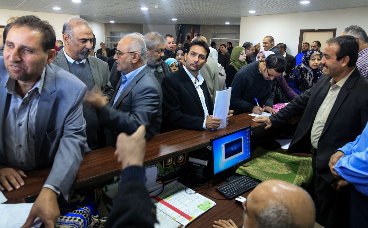 Government employees of the Palestinian Authority gather to return to work at the headquarters of the Palestinian Finance Ministry in Gaza City on November 29, 2017.  AFP / Mohammed Abed