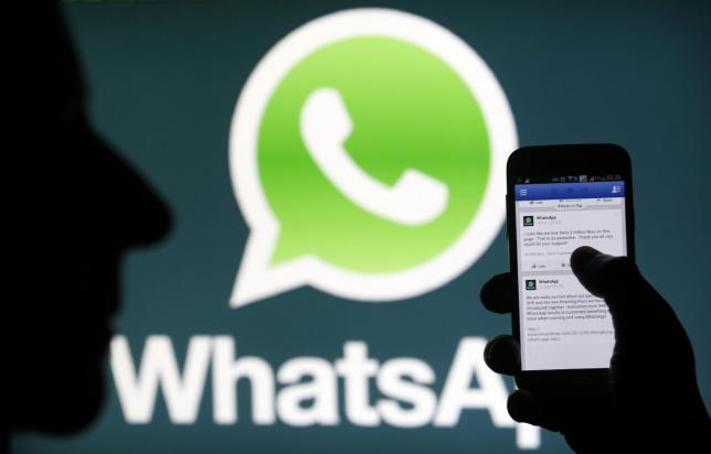 A Whatsapp App logo is seen behind a Samsung Galaxy S4 phone that is logged on to Facebook in the central Bosnian town of Zenica, February 20, 2014 (Reuters) 