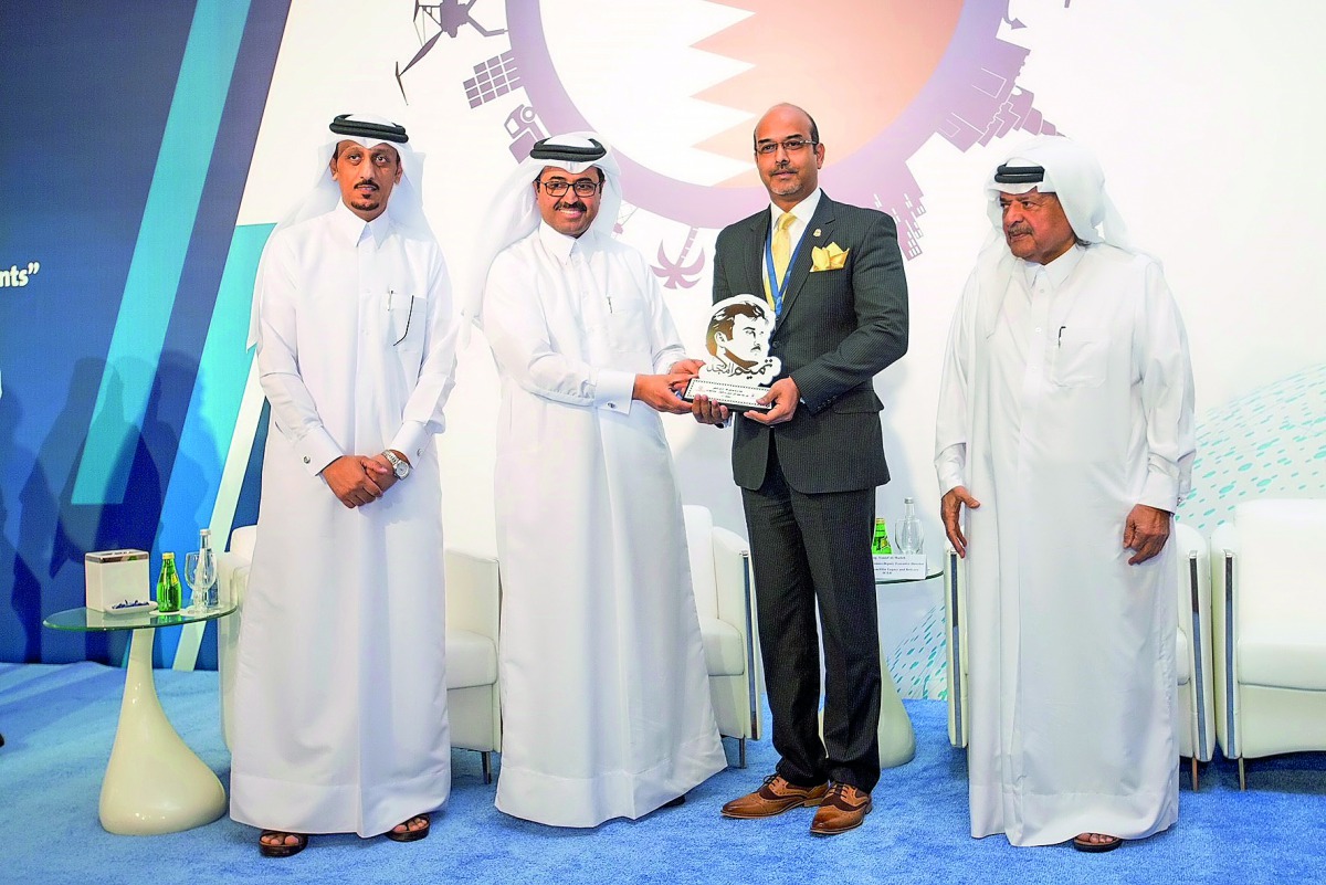 Arnab Mukherjee (second right), Vodafone Qatar’s Business Continuity Manager receiving an award on behalf Vodafone Qatar from H E Dr Mohammed bin Saleh Al Sada (second left), Minister of  Energy and Industry, as Sheikh Faisal bin Qassim Al Thani (right) ,