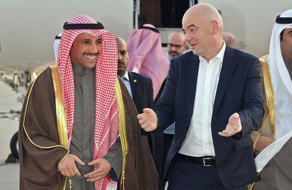 A photo release by the Kuwait news agency KUNA on December 6, 2017 shows Kuwaiti national assembly speaker Marzouq al-Ghanim (L) receiving FIFA president Gianni Infantino at Kuwait international airport in Kuwait City.   AFP / Kuwait News Agency 