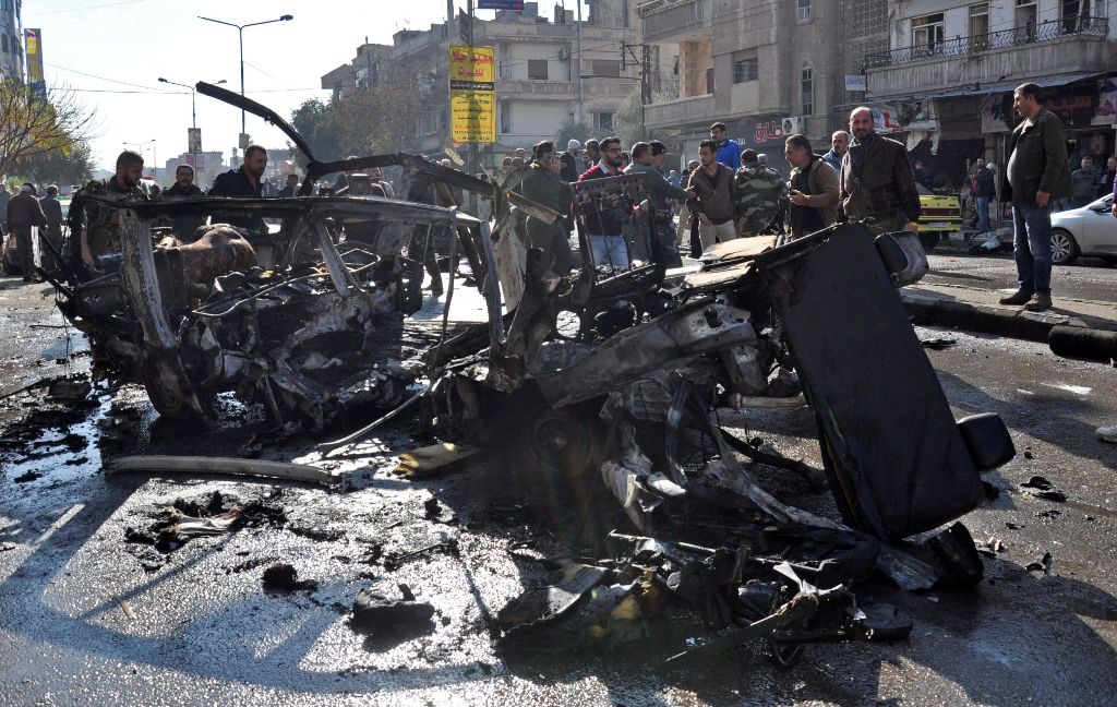 Emergency services and civilians gather at the scene of a car bomb explosion in a predominantly pro-government neighbourhood of the central Syrian city of Homs on December 5, 2107.AFP 