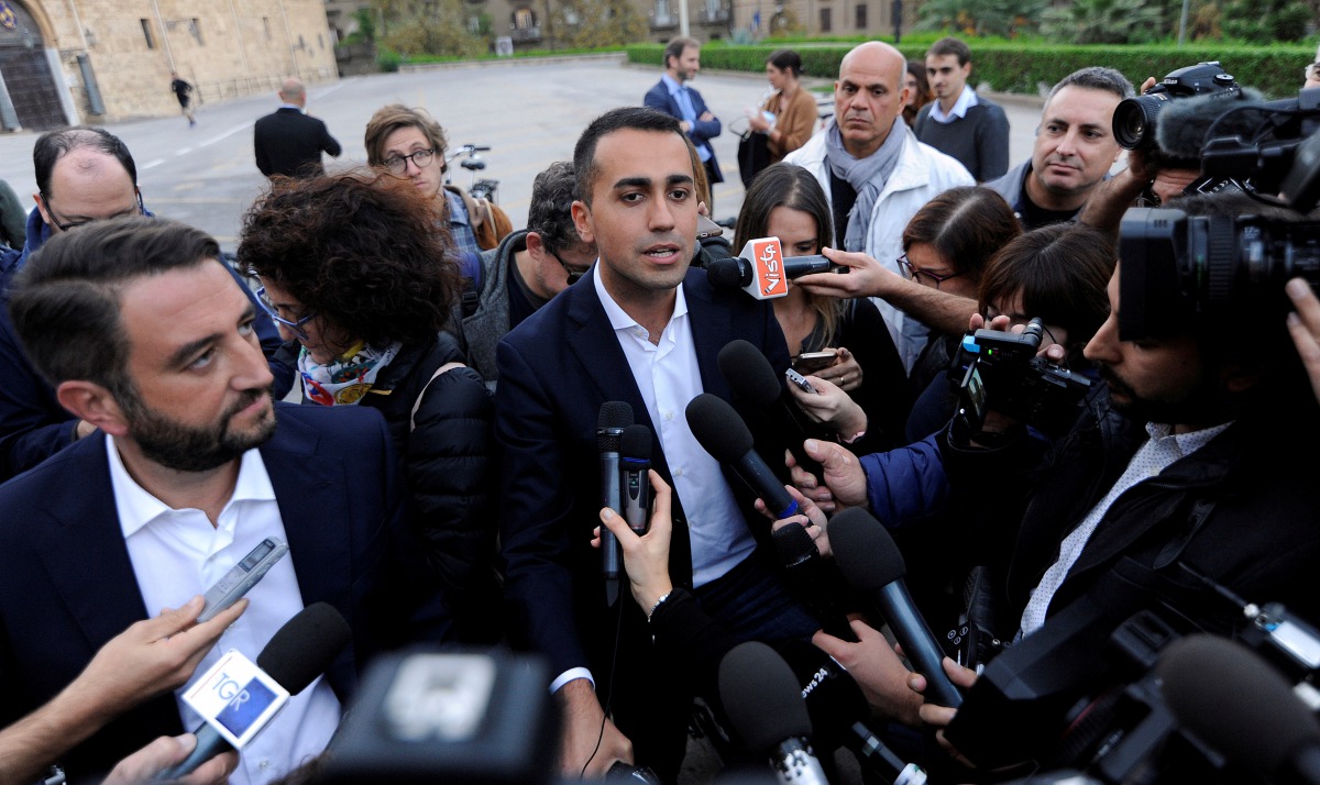 5-Star Movement Luigi Di Maio (C) and Giancarlo Cancelleri speak with media prior to a rally for a regional election in Palermo, Italy, November 3, 2017. REUTERS/Guglielmo Mangiapane/File Photo
