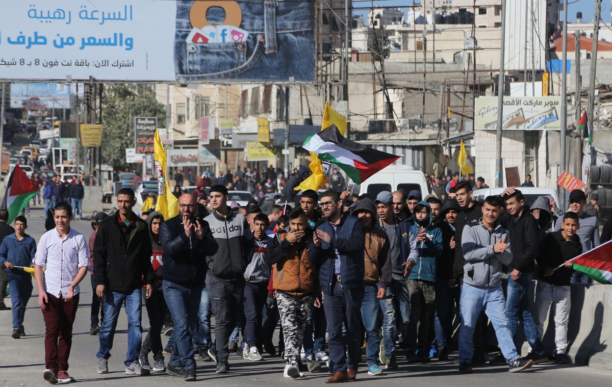 RAMALLAH, WEST BANK: Palestinian protesters march during their demonstration against U.S. President Donald Trump's recognition of Jerusalem as Israel's capital, near Qalandia checkpoint in West Bank between Jerusalem and Ramallah on December 8, 2017. (?ss