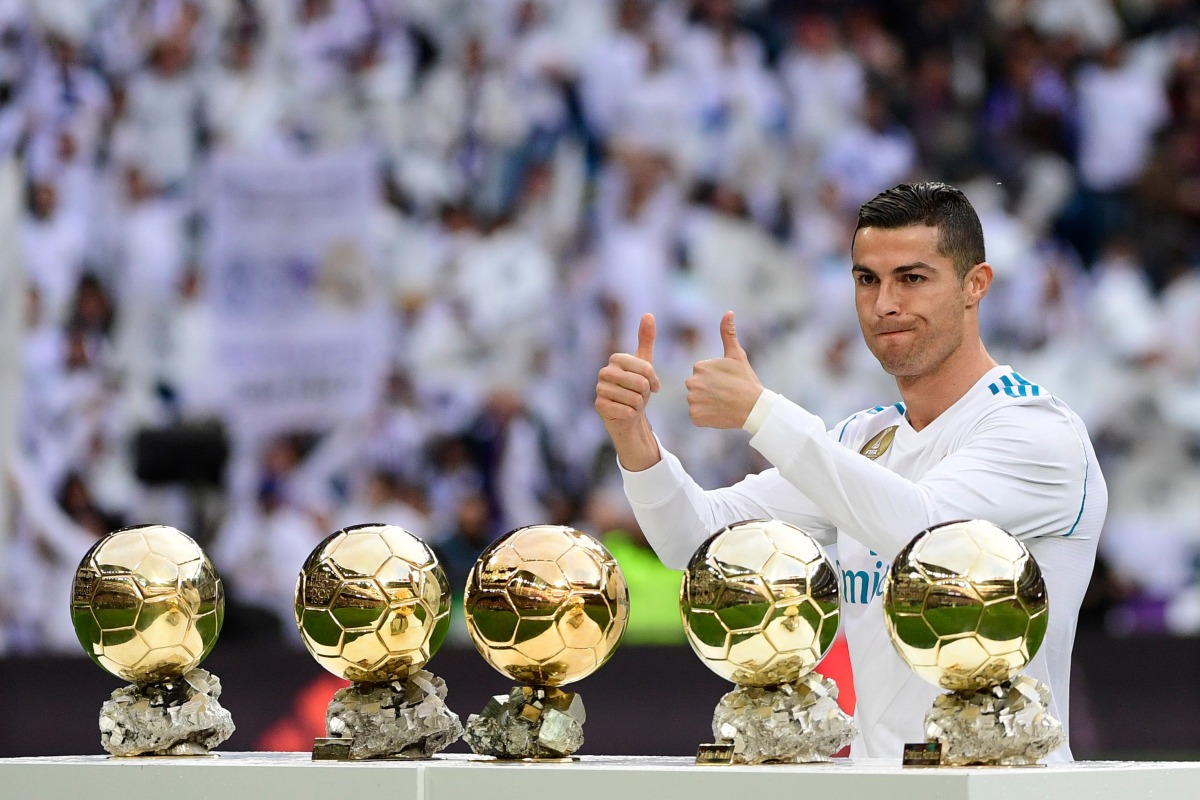 Real Madrid's Portuguese forward Cristiano Ronaldo poses with his five Ballon d'Or trophies ahead of the Spanish league football match between Real Madrid and Sevilla at the Santiago Bernabeu Stadium in Madrid on December 9, 2017. (AFP / PIERRE-PHILIPPE M