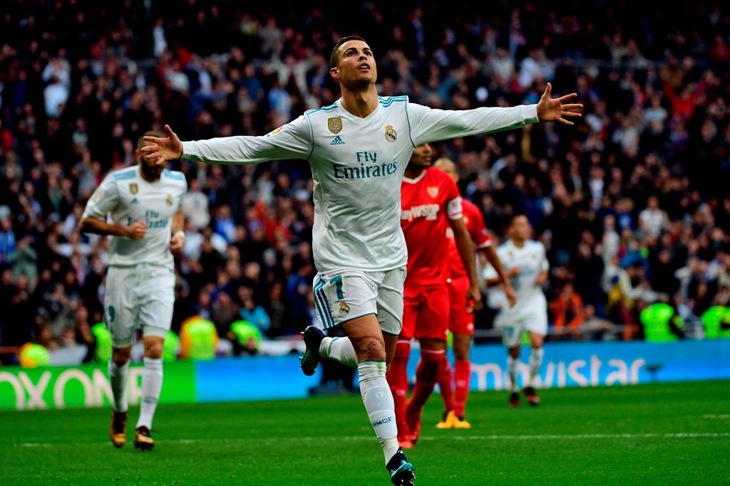 Real Madrid's Portuguese forward Cristiano Ronaldo celebrates after scoring a goal during the Spanish league football match between Real Madrid and Sevilla at the Santiago Bernabeu Stadium in Madrid on December 9, 2017. / AFP / PIERRE-PHILIPPE MARCOU
