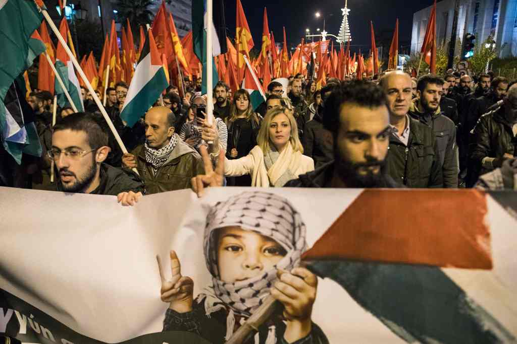 Members of the Greek communist party KKE take part in a demonstration in Athens on December 8, 2017, after US President Donald Trump's controversial order recognising 
Jerusalem as Israel's capital. / AFP.