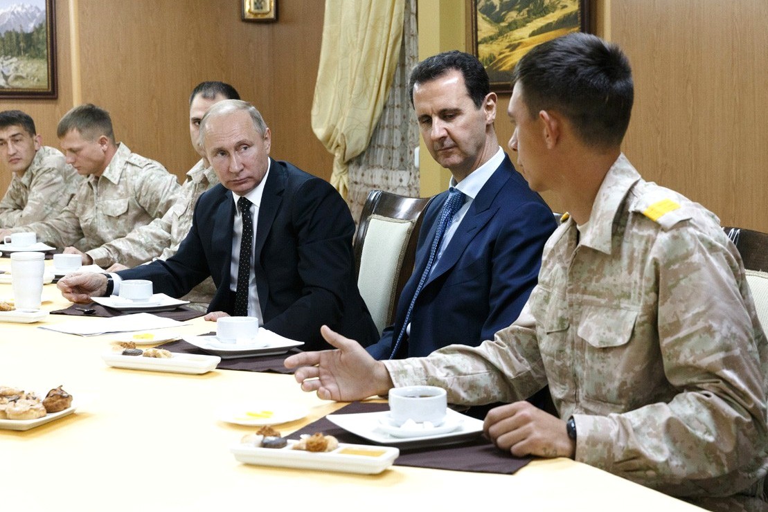 Russian President Vladimir Putin (3 R) meets with President of Syria, Bashar al-Assad (2 R) during his visit at the Hmeymim base in Syria's Latakia on December 11, 2017.  Kremlin Press Office