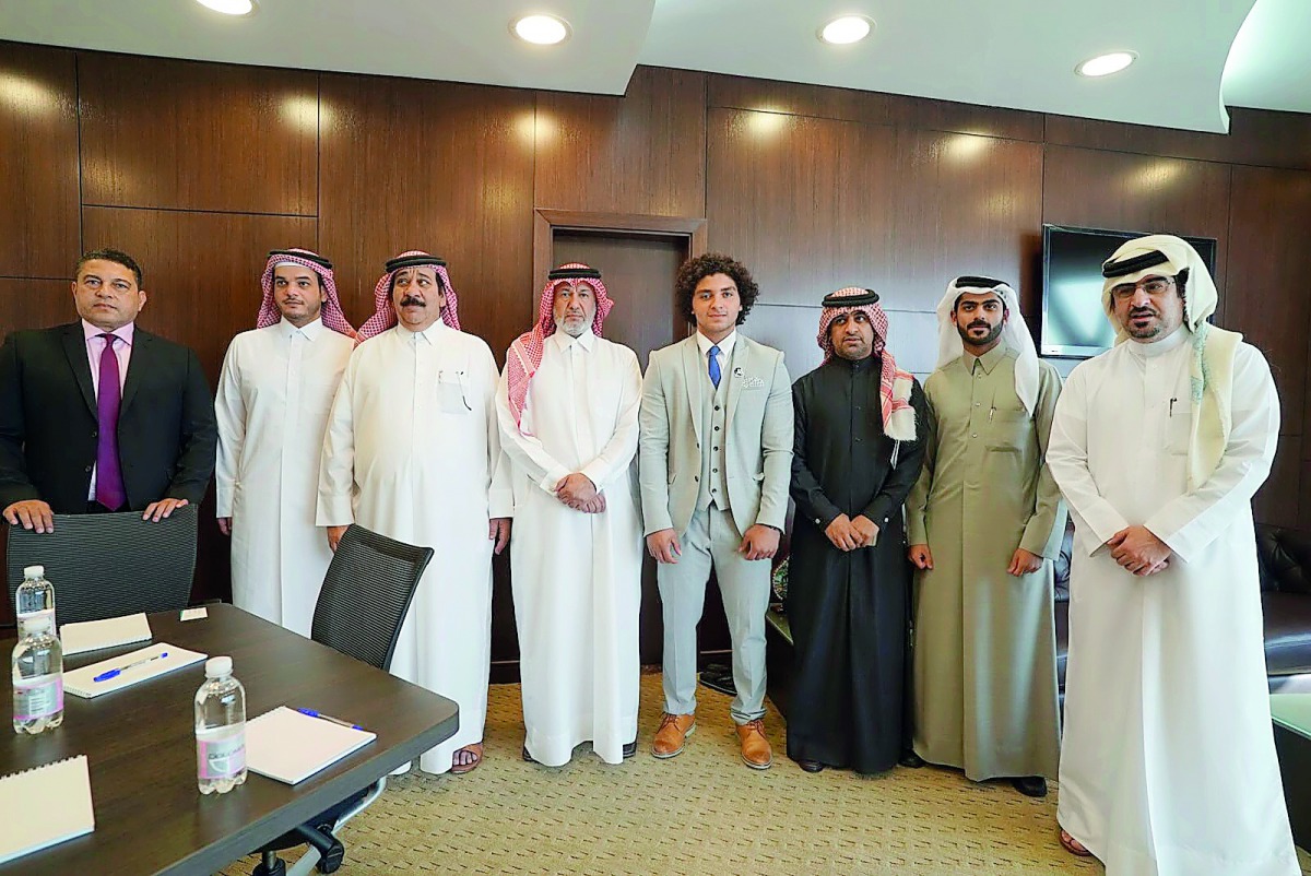 Hassouna (fifth left) poses for a photograph with the President of QFWF, Mohamed Yousef Al Mana and other officials.