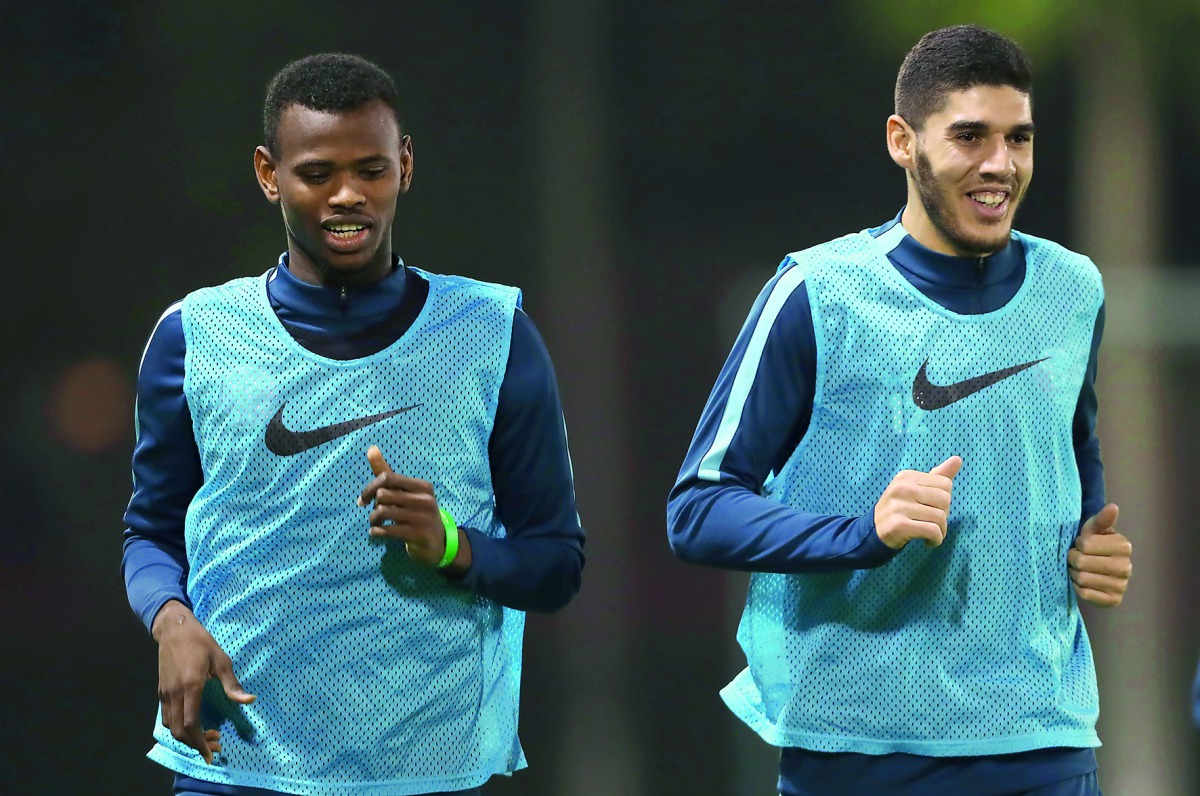 Qatar’s Karim Boudiaf (right) and a team-mate train under the watchful eyes of coach Felix Sanchez.