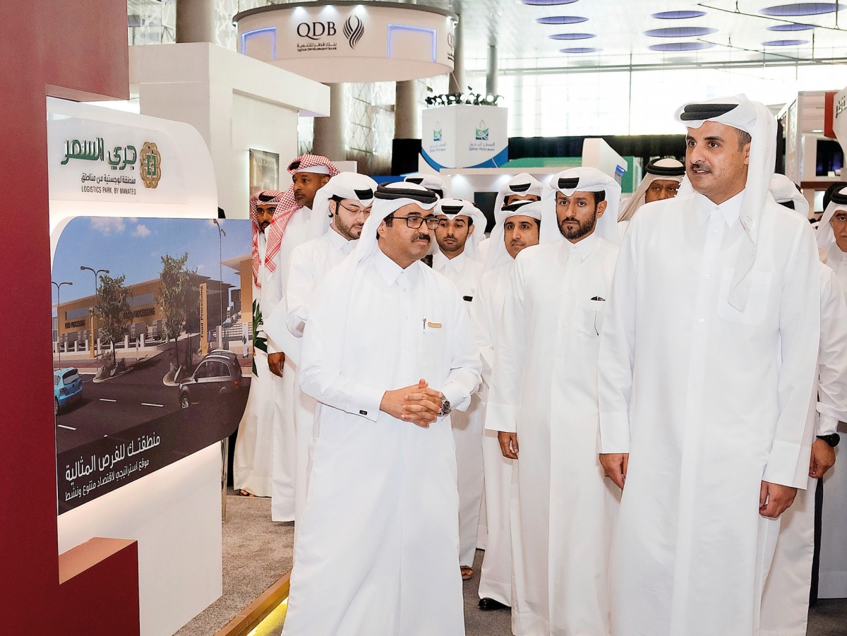Emir H H Sheikh Tamim bin Hamad Al Thani and the Minister of Energy and Industry H E Dr Mohammed bin Saleh Al Sada taking a tour of the fifth edition of ‘Made in Qatar’ exhibition after the inauguration at DECC, yesterday. 