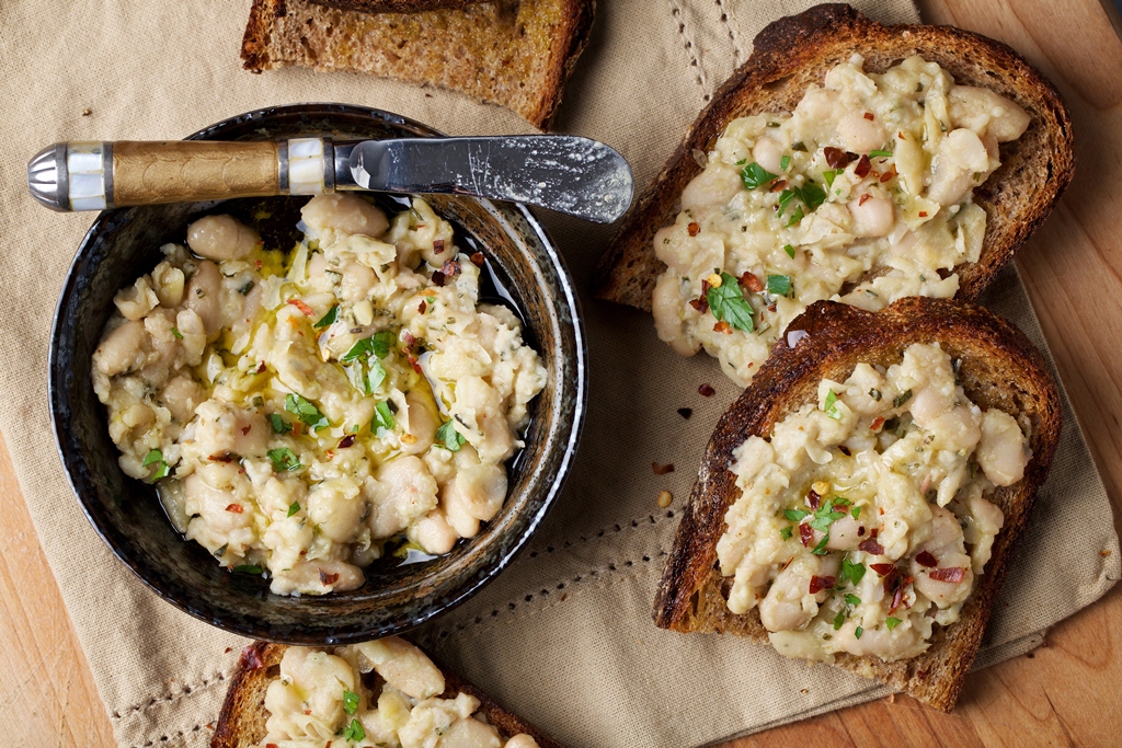 Garlic-Rosemary White Bean Toasts take all of 15 minutes to whip up with ingredients that are easy to keep on hand - so it's perfect for surprise guests. (Photo by Deb Lindsey for The Washington Post)
