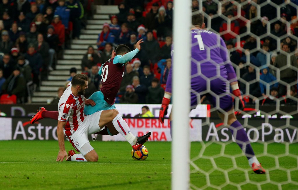 Stoke City's Erik Pieters fouls West Ham United's Manuel Lanzini and referee Graham Scott consequently awards a penalty REUTERS/Andrew Yates 
