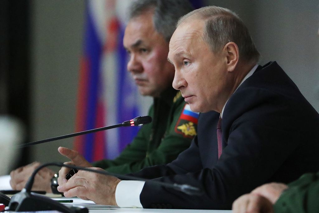 Russian President Vladimir Putin and Defence Minister Sergei Shoigu attend a meeting of Russia's top military brass in Balashikha outside Moscow on December 22, 2017. / AFP / SPUTNIK / Mikhail KLIMENTYEV
