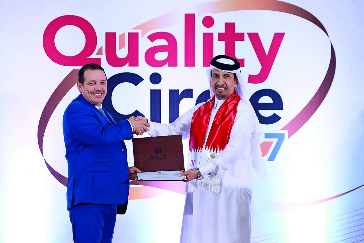 Ali bin Hassan Al Muraikhi (right), Managing Director & General Manager of Qatar Steel gives away an award to Anthony Norton Nash, HSE Manager, during the Quality Control Circle event at Al Reem Club in Mesaieed.