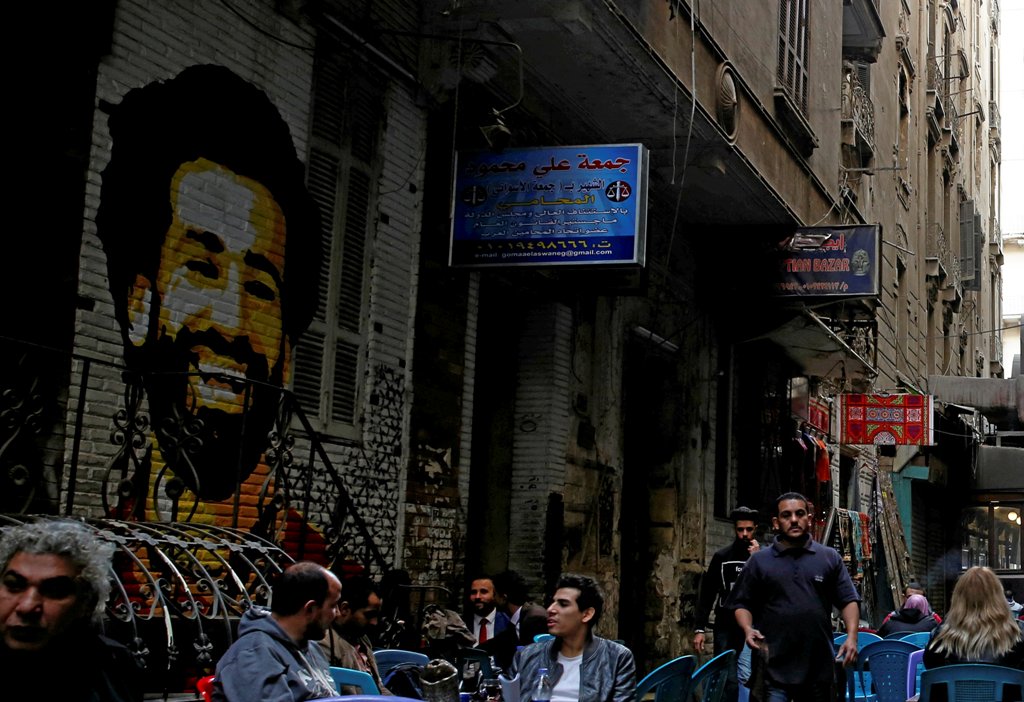 A picture of Liverpool's Egyptian midfielder Mohamed Salah is seen as people sit outside a coffee shop in Cairo, Egypt December 24, 2017. REUTERS/Amr Abdallah Dalsh