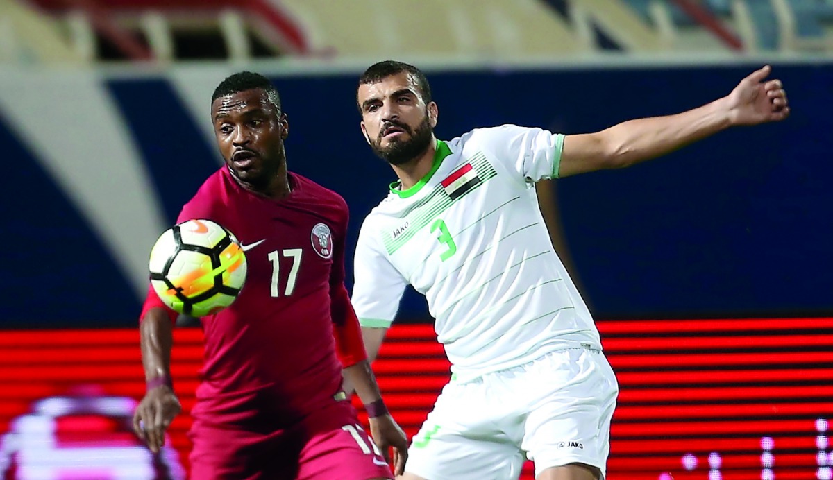 Qatari Ismail Mohammed (left) and Iraqi defender Ali Bahjat vie for the ball possession during their Group B match of the 23rd Gulf Cup Football Tournament played in Kuwait City yesterday. Pictures: Hussein Sayed