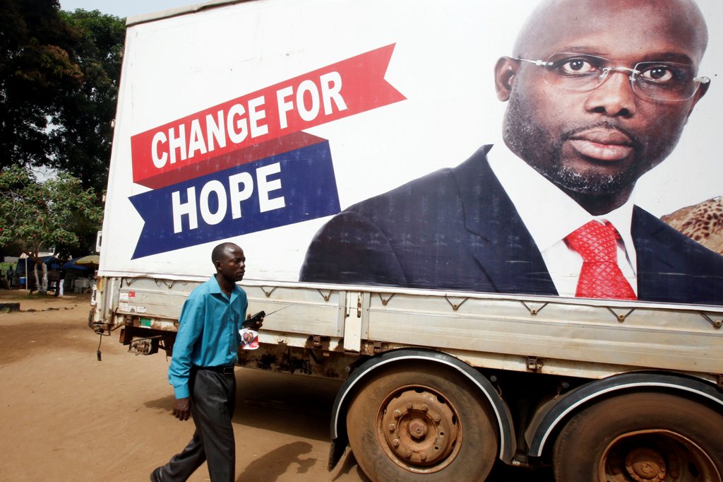 A supporter of George Weah, former soccer player and presidential candidate of Coalition for Democratic Change (CDC), listens to the announcement of the presidential election results on the radio, in Monrovia, Liberia December 27, 2017. REUTERS/Thierry Go