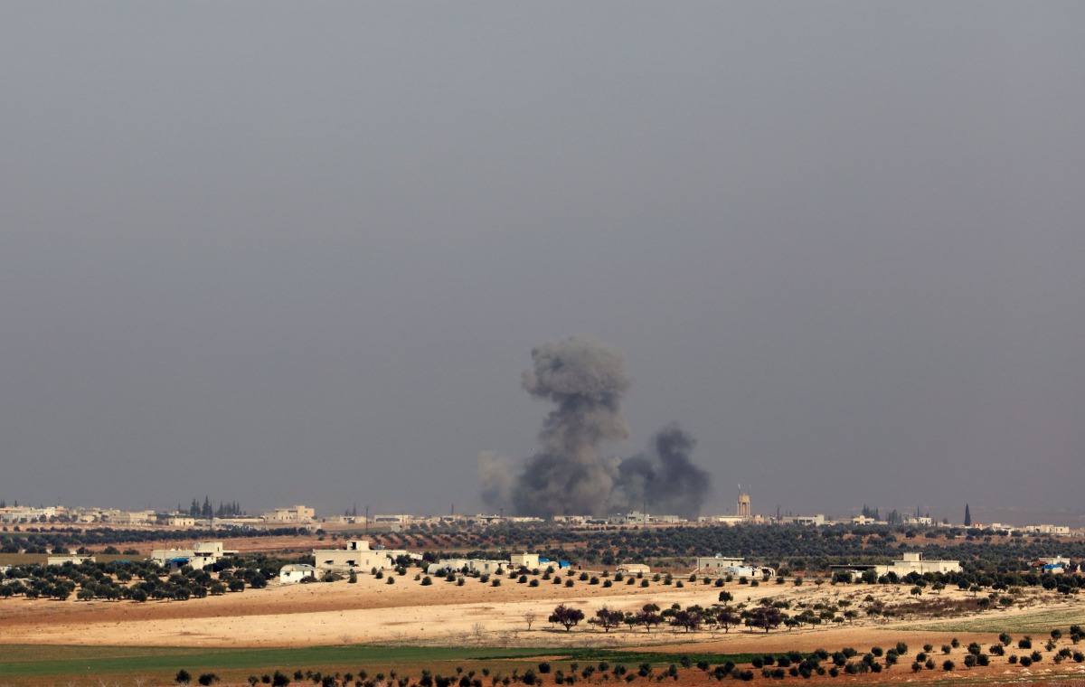 A picture taken on December 29, 2017, from a village in southern Idlib, shows smoke billowing following reported airstrikes on the village of Um Jalal in Syria's northwestern Idlib province.   AFP / OMAR HAJ KADOUR

