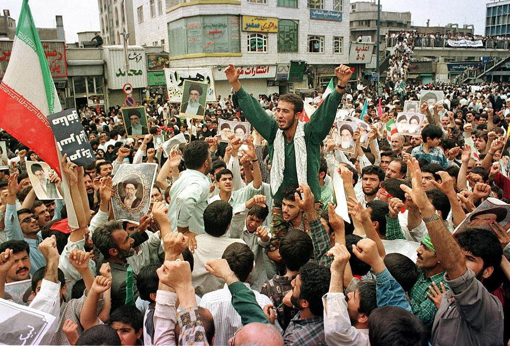 This file photo taken on July 14, 1999 shows Iranian demonstrators participating in a rally in support of the Islamic regime at Tehran University campus. / AFP / HENGHAMEH FAHIMI.
