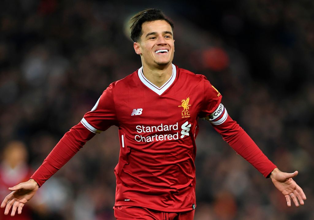 (FILES) This file photo taken on December 26, 2017 shows Liverpool's Brazilian midfielder Philippe Coutinho celebrating scoring the opening goal of the English Premier League football match between Liverpool and Swansea City at Anfield in Liverpool, north