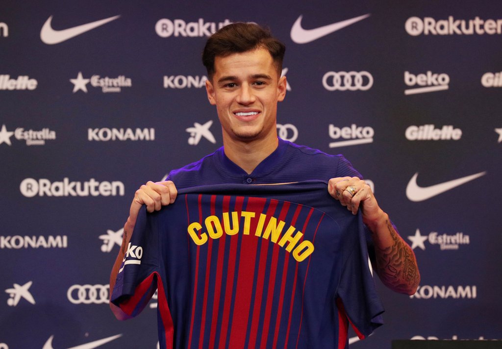 FC Barcelona's new signing Philippe Coutinho poses with the club shirt REUTERS/Albert Gea
