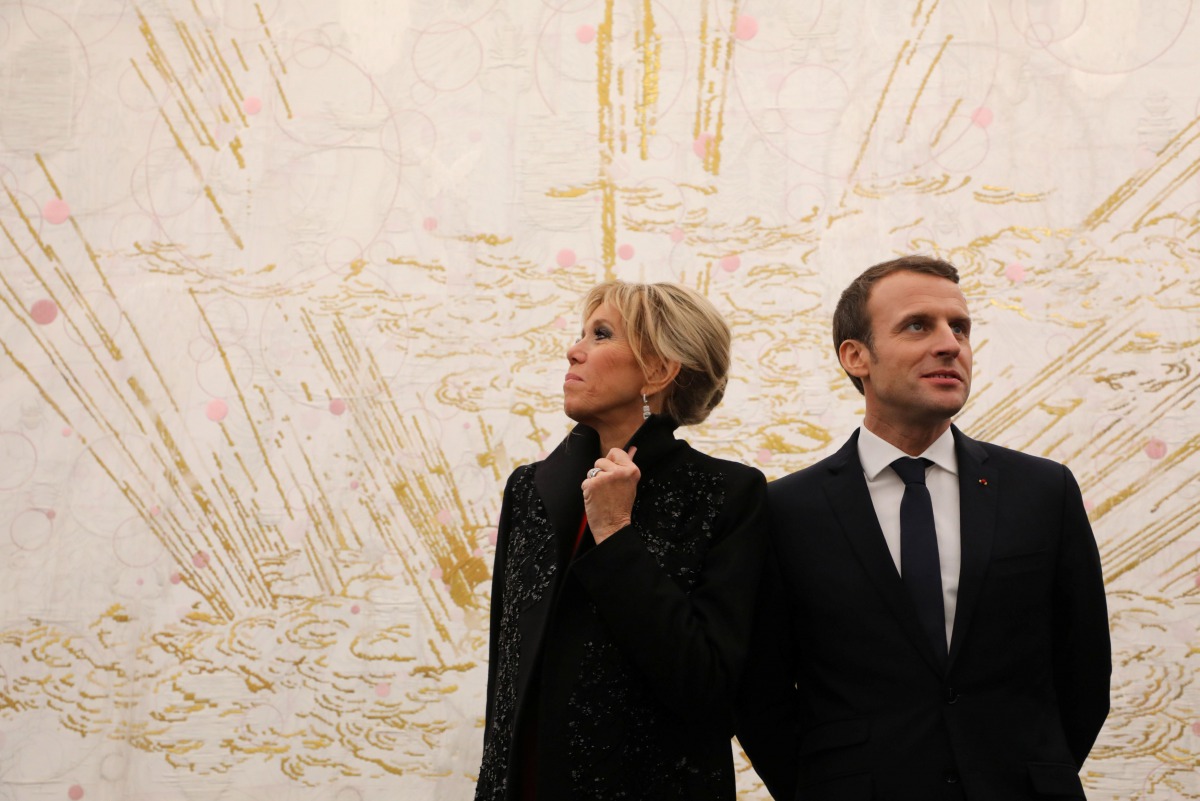 French President Emmanuel Macron (R) and his wife Brigitte Macron (L) visit the Ullens Chinese Contemporary Art Centre in Beijing January 9, 2018. Picture taken January 9, 2018. Reuters/Ludovic Marin