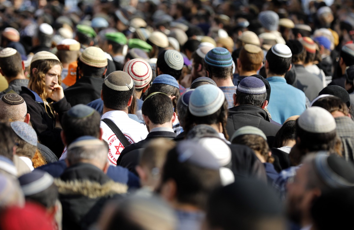 Israeli mourners attend the funeral of 35-year-old rabbi Raziel Shevah in the West Bank wildcat settlement of Havat Gilad near Nablus on January 10, 2018.  AFP / Menahem Kahana