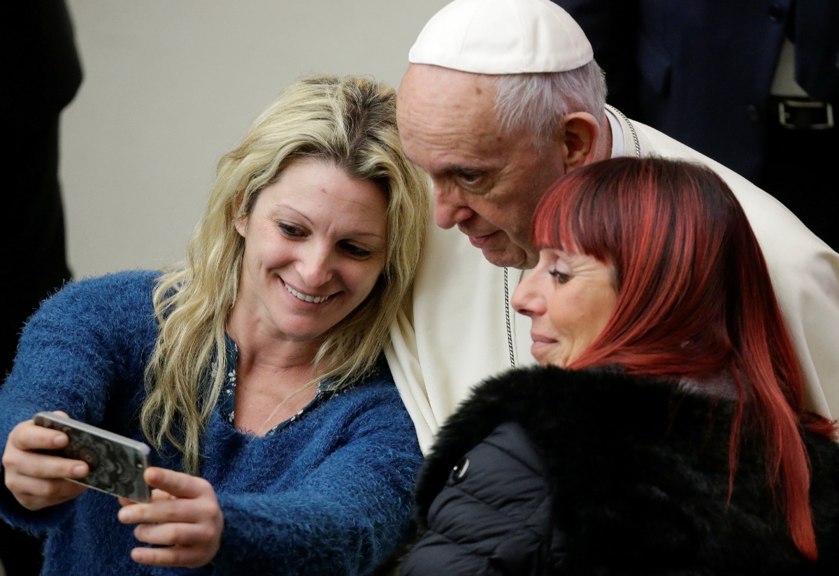 Pope Francis poses for a selfie as he leads the general audience in Paul VI hall at the Vatican January 10, 2018. Reuters/Max Rossi