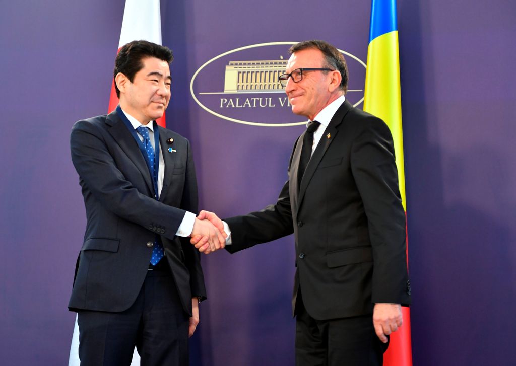 Romanian vice Prime Minister Paul Stanescu (R) welcomes Kotaru Nogami (L), Deputy chief Cabinet Secretary, leader of Japan's official economic delegation, at The Victoria Palace, the headquarters of the Romanian Government on January 16, 2018 in Bucharest