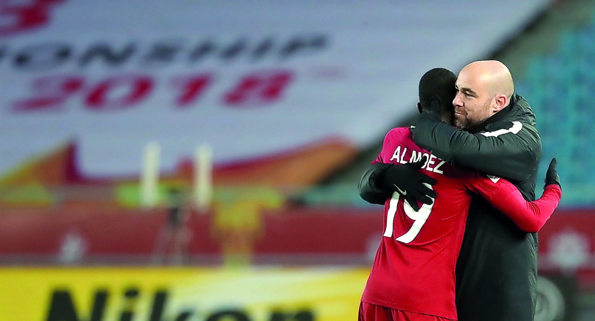 Qatar coach Felix Sanchez celebrates with striker Almoez Ali after the latter scored the winning goal against Uzbekistan during the AFC U-23 Asian Cup in China on January 9.