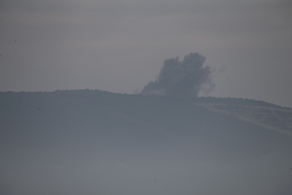 A photo taken from Turkey's Hatay shows smokes rising as Turkish military aircrafts continue to hit PYD/PKK terror group targets within the 'Operation Olive Branch' launched in Syria's Afrin, on January 21, 2018 in Hatay, Turkey. Cem Genco - Anadolu 
