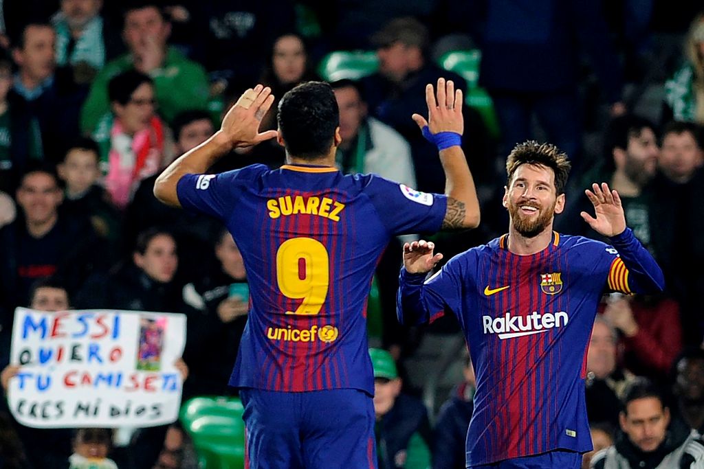 Barcelona's Argentinian forward Lionel Messi (R) celebrates with Barcelona's Uruguayan forward Luis Suarez after scoring a goal during the Spanish league football match between Real Betis and FC Barcelona at the Benito Villamarin stadium in Sevilla on Jan