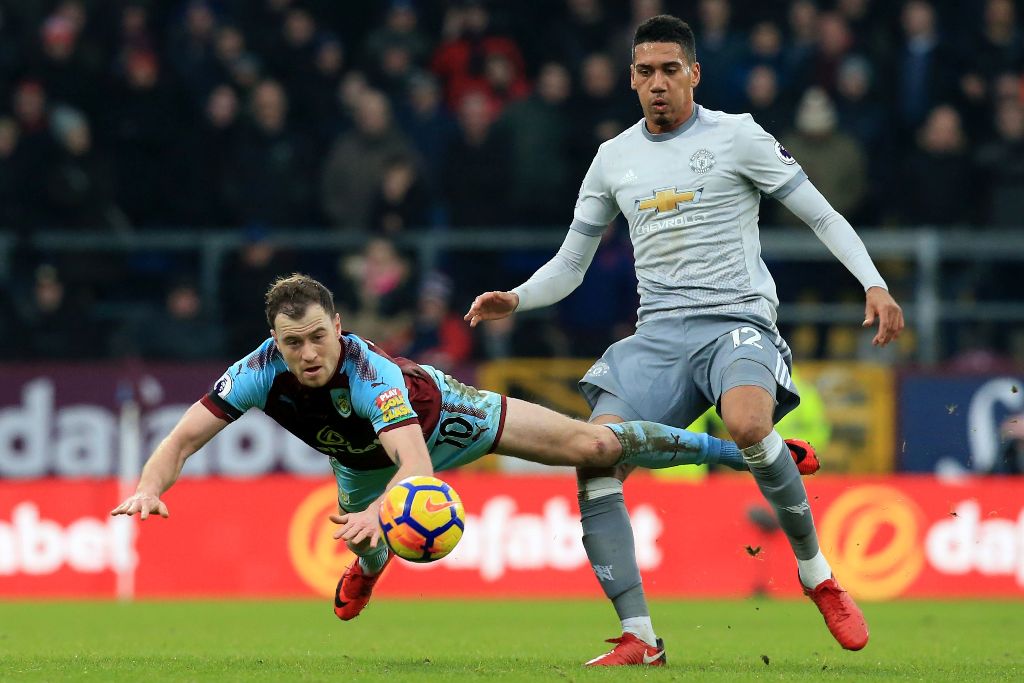 Manchester United's English defender Chris Smalling (R) vies with Burnley's English striker Ashley Barnes (L) during the English Premier League football match between Burnley and Manchester United at Turf Moor in Burnley, north west England on January 20,