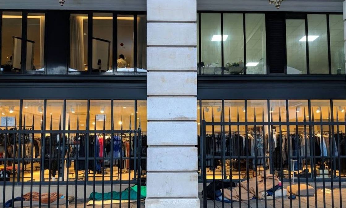 A homeless person sleeps on a street that has been fenced off near Paris' Saint-Lazare station, December 19, 2017. Thomson Reuters Foundation/Anna Pujol-Mazzini