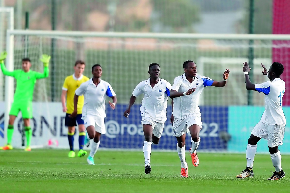 Aspire Football Dreams players celebrate their goal yesterday.
