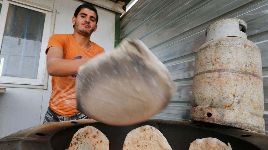 A Syrian refugee makes bread to sell at the Zaatari refugee camp in Mafraq, Jordan, January  8, 2015. Reuters/Muhammad Hamed