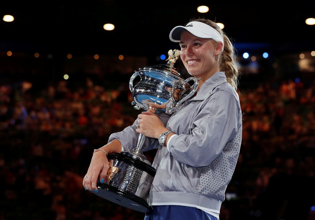  Denmark's Caroline Wozniacki celebrates with the trophy after winning the final against Romania's Simona Halep. REUTERS/Issei Kato
