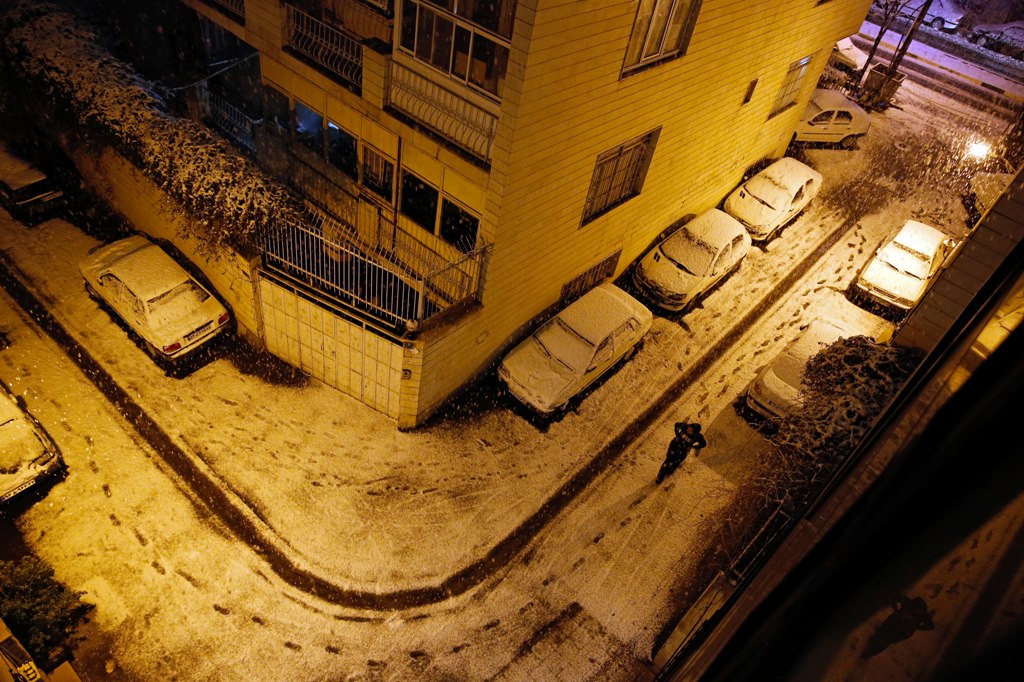 An Iranian man walks in an ally during a heavy snowfall in Tehran, Iran, 27 January 2018. EPA/ABEDIN TAHERKENAREH