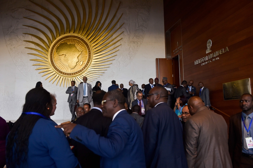 Delegates leave the plenary hall of the Africa Union (AU) headquarters, before the start of the 30th Ordinary Session of the Assembly of Heads of State and Government of the AU in Addis Ababa on January 27, 2018. / AFP / SIMON MAINA