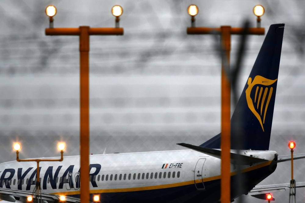 (FILES) This file photo taken on December 15, 2017 shows a plane of Irish low-cost airline company Ryanair on the tarmac of Rome's Ciampino airport.  AFP / Alberto PIZZOLI