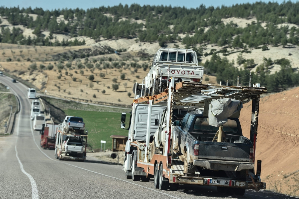 A military convoy carries Turkish-backed Syrian rebel fighter and rebels's vehicles as they are dispatched to the border in Kilis, near the Turkish-Syrian border on January 29, 2018, as part ot the operation 