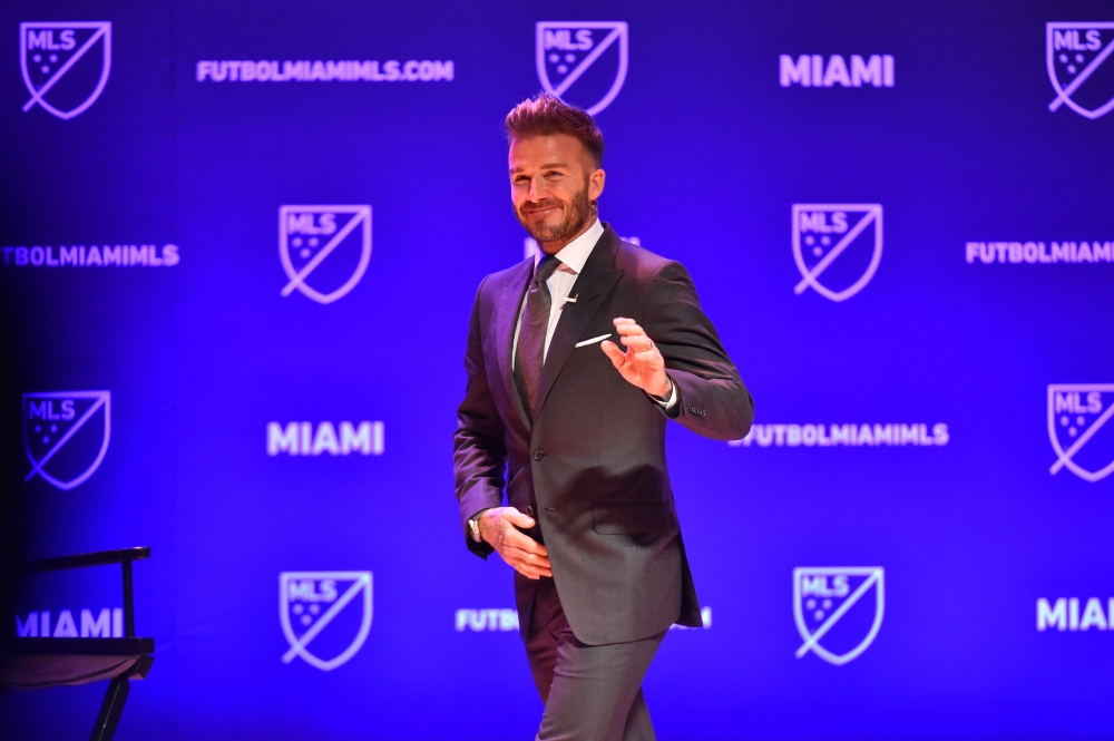 David Beckham waves to the crowd at the beginning of the press conference awarding Miami with an MLS franchise at the Knight Concert Hall on January 29, 2018 in Miami, Florida. Eric Espada/AFP 